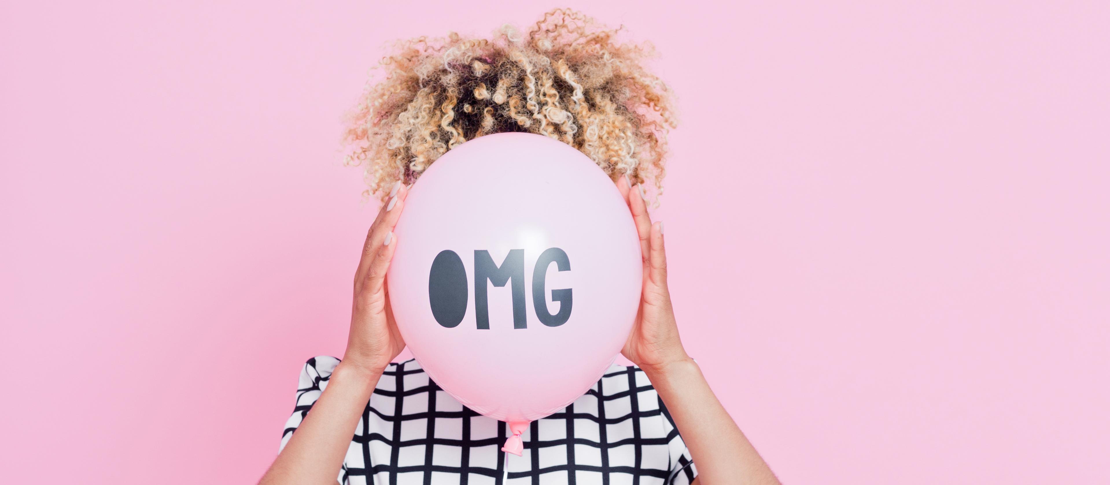 Woman with pink OMG balloon