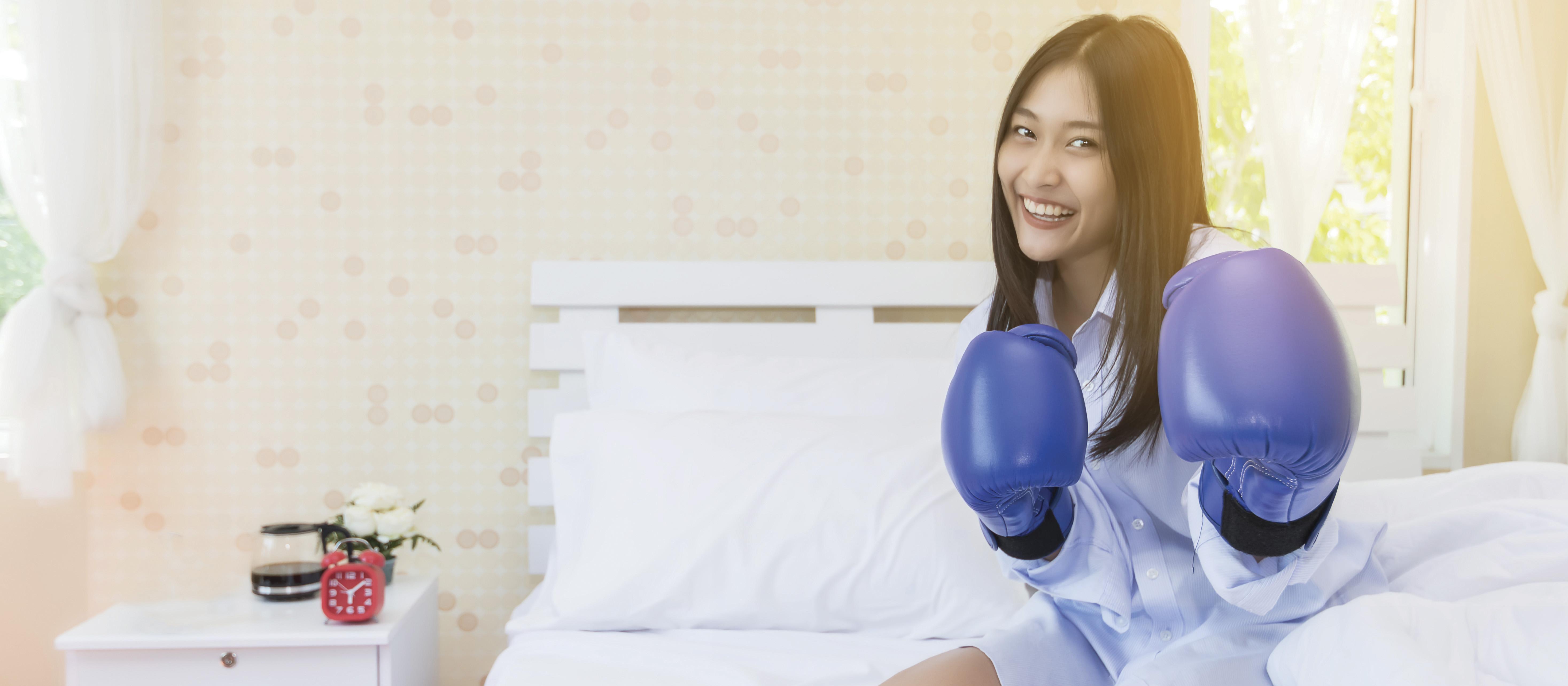 Asian woman boxing glove bedroom