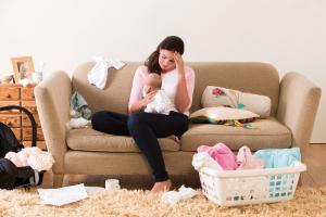 Tired mother with newborn baby